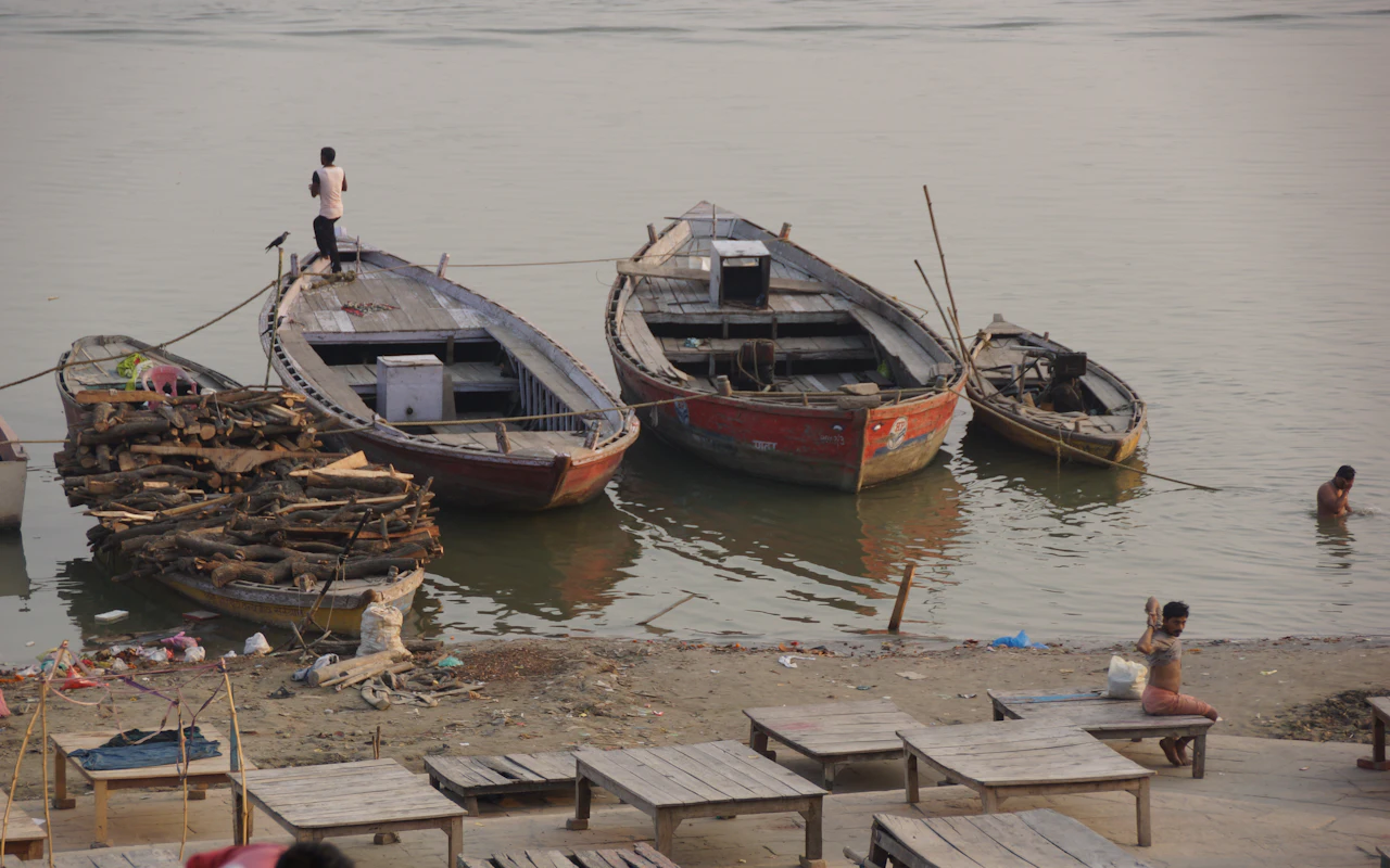 Boats resting on the riverbank beside the ghats of Varanasi