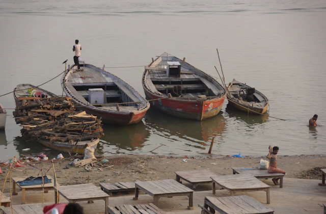 Boats resting on the riverbank beside the ghats of Varanasi
