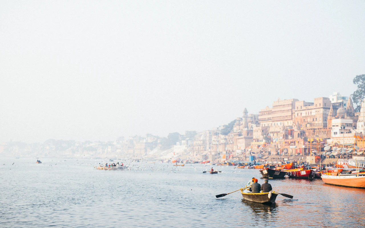 People rowing wooden boats on the Ganga at Varanasi