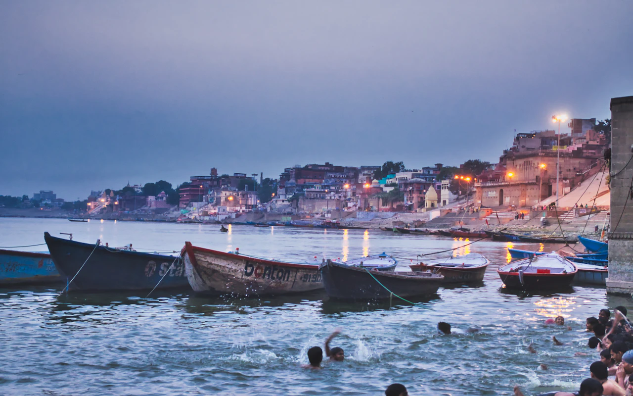 Morning blue-hour view of boats and the riverfront cityscape at Varanasi